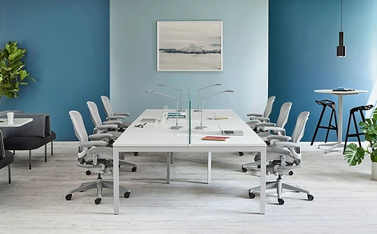 Herman Miller Aeron chairs showcasing their sleek design and ergonomic features around a table